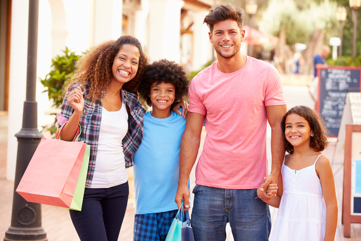 A portrait of a family with shopping bags