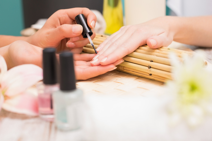 Nail technician giving customer a manicure