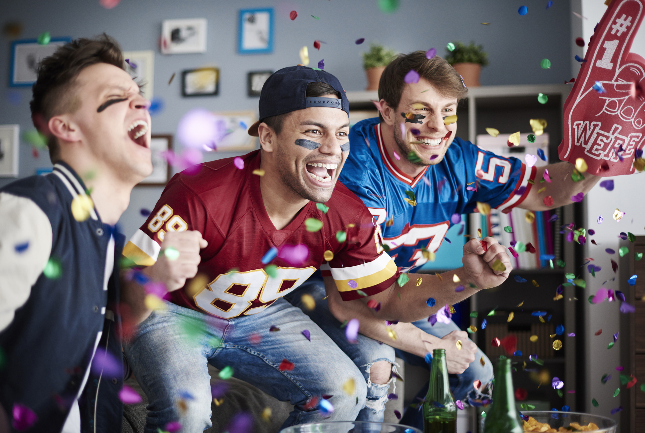 American football fans among falling confetti