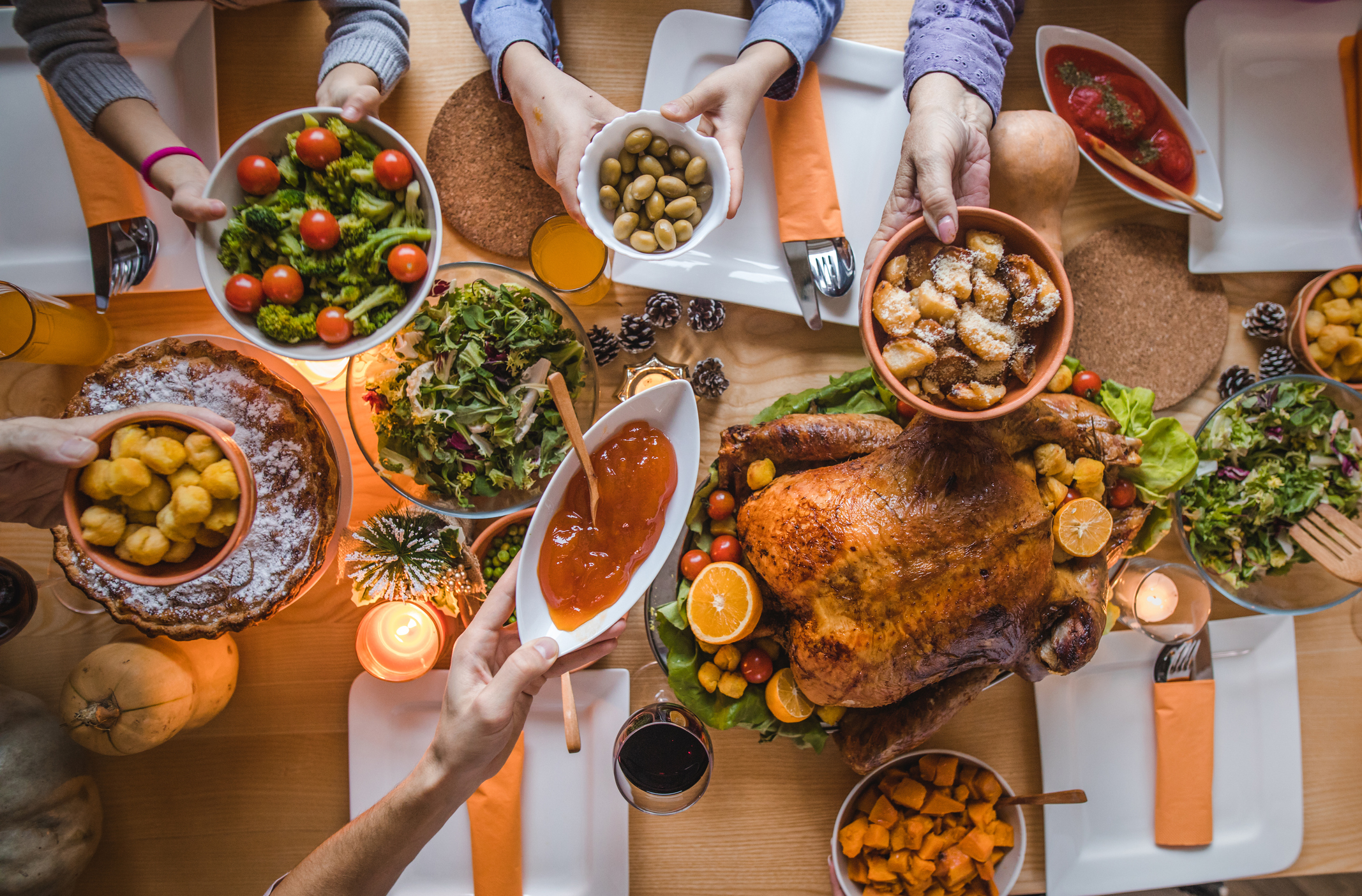 Above view of passing food during Thanksgiving dinner.